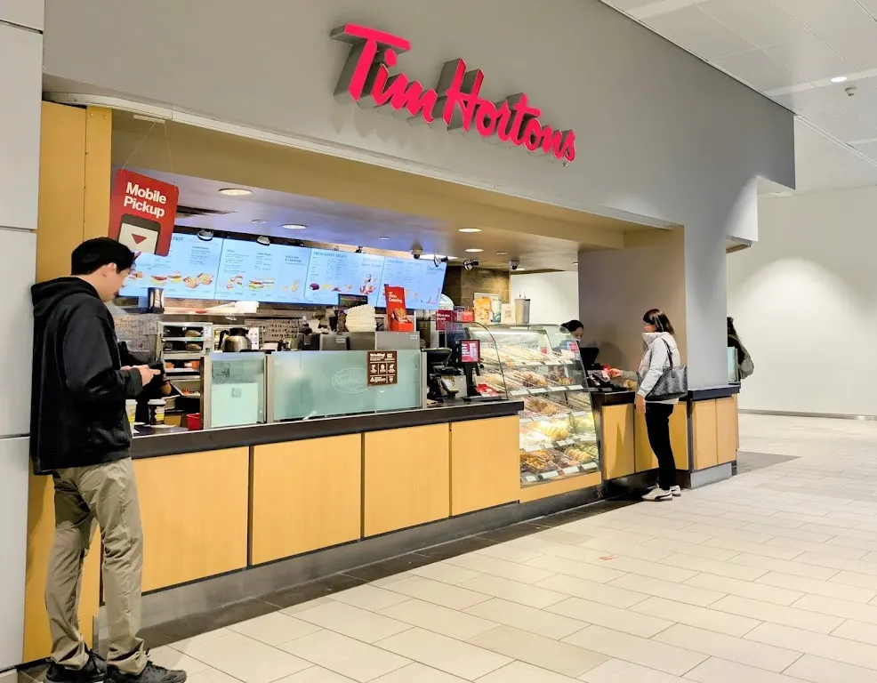 Tim Hortons storefront and interior at 101 College St, Toronto, ON